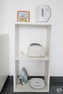 a white shelf with a toaster and a toilet on it at Apartamento Estefânia in Santa Cruz