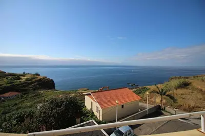 a house with a view of the ocean at Portinho II-Modern apt with balcony facing the sea in Caniço