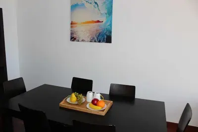 a black table with a tray of fruit on it at Portinho II-Modern apt with balcony facing the sea in Caniço