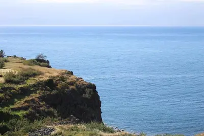 a view of the ocean from atop a hill at Portinho II-Modern apt with balcony facing the sea in Caniço