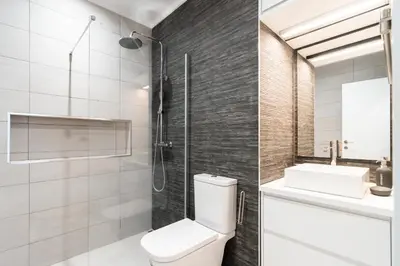 a bathroom with a shower and a toilet and a sink at Villa Ponta do Sol Apartment in Ponta do Sol