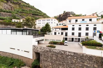 a view of a building with a car parked in front at Villa Ponta do Sol Apartment in Ponta do Sol