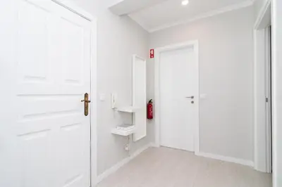 a hallway with white walls and white doors at Villa Ponta do Sol Apartment in Ponta do Sol