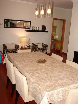 a dining room with a table and chairs at Garajau Elite in Caniço