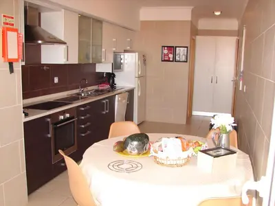 a kitchen with a table with a bowl of food on it at Garajau Elite in Caniço