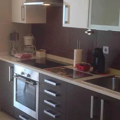 a kitchen with a sink and a stove top oven at Garajau Elite in Caniço