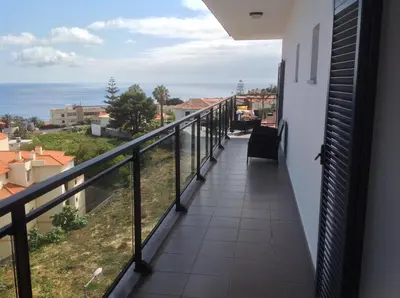 a balcony with a view of the ocean at Garajau Elite in Caniço