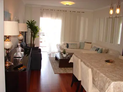 a living room with a table and a couch at Garajau Elite in Caniço