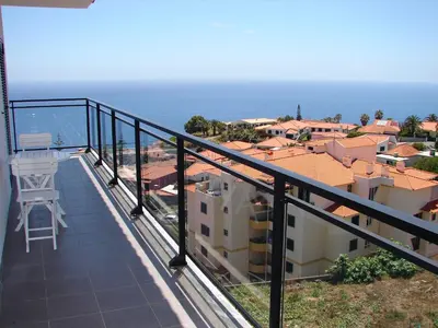a balcony with a view of a city at Garajau Elite in Caniço
