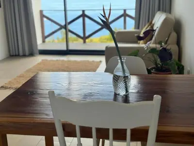 a wooden table with a vase on top of it at ModuLAR in Calheta