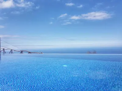 a view of a swimming pool in the ocean at ModuLAR in Calheta