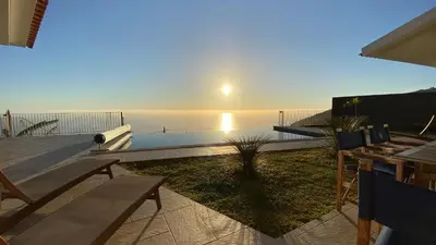 a view of the ocean from a house with a patio at Villa Palheiros in Arco da Calheta