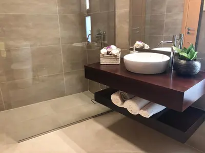 a bathroom with a sink and a shower at Villa Palheiros in Arco da Calheta
