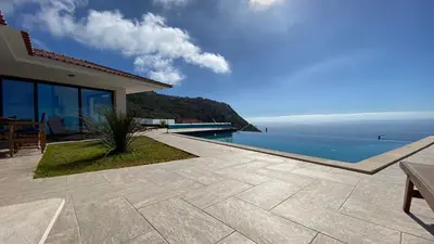a villa with a view of the ocean at Villa Palheiros in Arco da Calheta