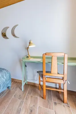a desk with a chair and a desk with a lamp at Casa Lua in Sagres
