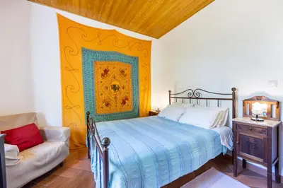 a bedroom with a bed and a couch at Casa Lua in Sagres