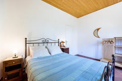 a bedroom with a bed and a wooden ceiling at Casa Lua in Sagres