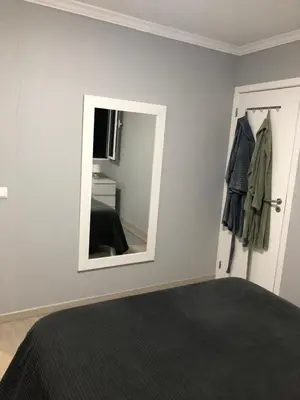 a bedroom with a mirror next to a bed at STUDIO'S HOUSE in Funchal