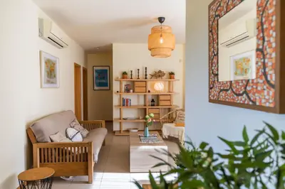 a living room with a couch and a chair at Casa Laranja, Aromas Burgau in Burgau