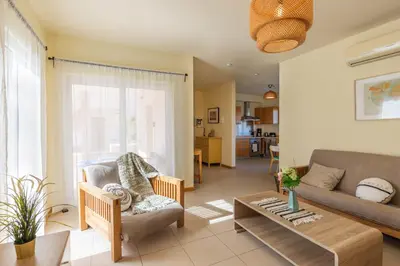a living room with a couch and a table at Casa Laranja, Aromas Burgau in Burgau