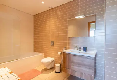 a bathroom with a toilet and a sink and a tub at Casa Laranja, Aromas Burgau in Burgau