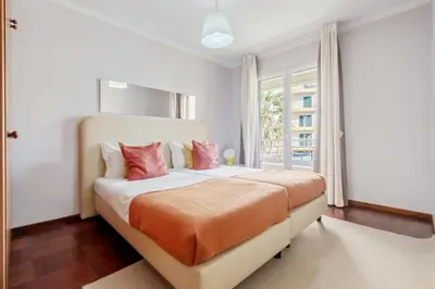 a bedroom with a large bed with red pillows at Piornais by Homie in Funchal