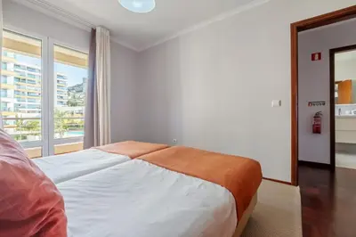 a bedroom with a bed and a large window at Piornais by Homie in Funchal