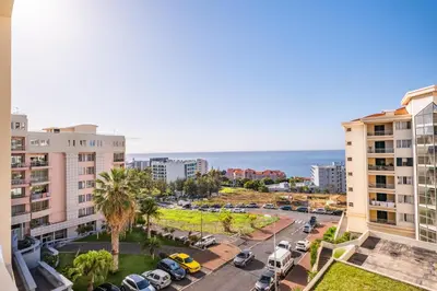 an aerial view of a city with buildings and the ocean at Piornais by Homie in Funchal