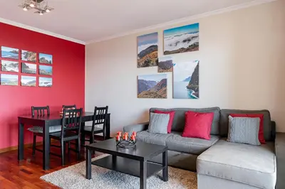 a living room with a couch and a table at Caniço V by An Island Apart in Caniço