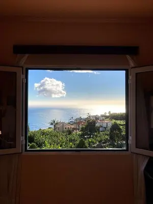 a window with a view of the ocean at Casa do Arco in Arco da Calheta