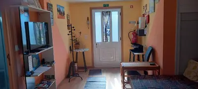 a living room with a television and a door at Top view in Ponta do Sol