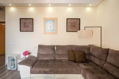 a bedroom with a bed and a lamp on a night stand at Atlantic Pearl America apartment by Holiday Rental Madeira in Funchal