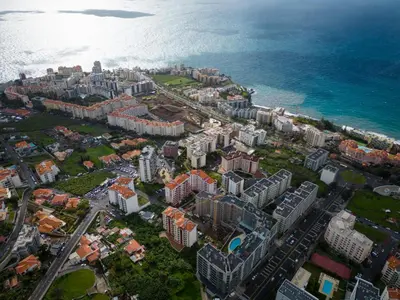 an aerial view of a city next to the ocean at Atlantic Pearl America apartment by Holiday Rental Madeira in Funchal