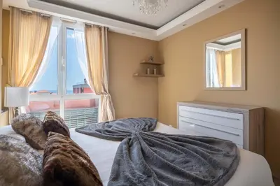 a bedroom with a large bed with a large window at Atlantic Pearl America apartment by Holiday Rental Madeira in Funchal