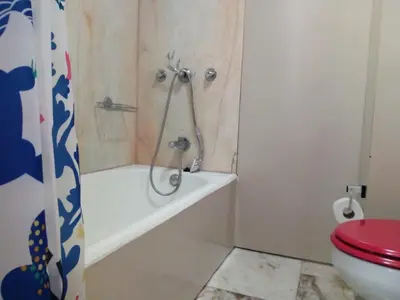 a bathroom with a tub and a toilet and a shower at Un Balcon Sur La Mer in Funchal