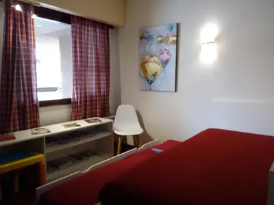 a bedroom with a red bed and a mirror at Un Balcon Sur La Mer in Funchal