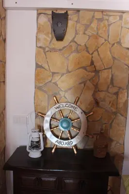 a stone wall with a steering wheel on a table at Casa Marreiros Holiday Home in Vila do Bispo