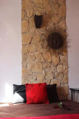a stone wall with a head on the wall at Casa Marreiros Holiday Home in Vila do Bispo