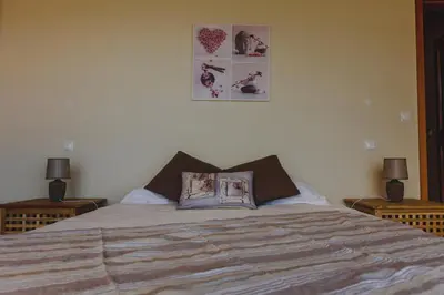 a bedroom with a large bed with two lamps at Sunrise House in Ponta Delgada