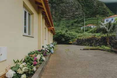 a building with flowers on the side of it at Sunrise House in Ponta Delgada