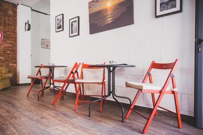 a row of chairs and tables in a restaurant at Ardmar B&B in Vila do Bispo