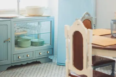 a blue cabinet with dishes inside of it at Ardmar B&B in Vila do Bispo