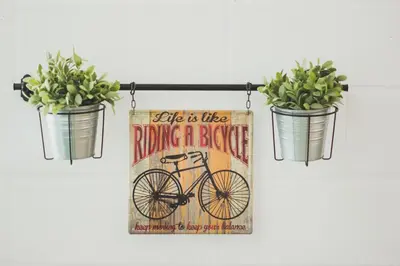 a sign hanging on a wall with two potted plants at Ardmar B&B in Vila do Bispo