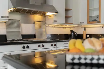 a kitchen with a stove and a bowl of fruit at Pool Villa with Botanical Garden in Funchal