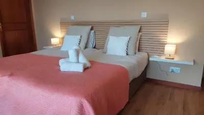 a bedroom with a large bed with a chair on it at Pool Villa with Botanical Garden in Funchal