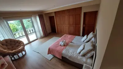 a bedroom with a bed and a large window at Pool Villa with Botanical Garden in Funchal