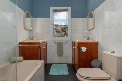 a bathroom with a sink toilet and a window at Pool Villa with Botanical Garden in Funchal