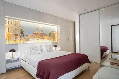 a bedroom with a large bed with a large window at Baía I by An Island Apart in Funchal