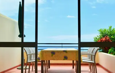 a table and two chairs on a balcony at Jardim do Arco 