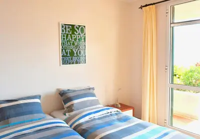 a bedroom with two beds with blue and white pillows at Jardim do Arco 